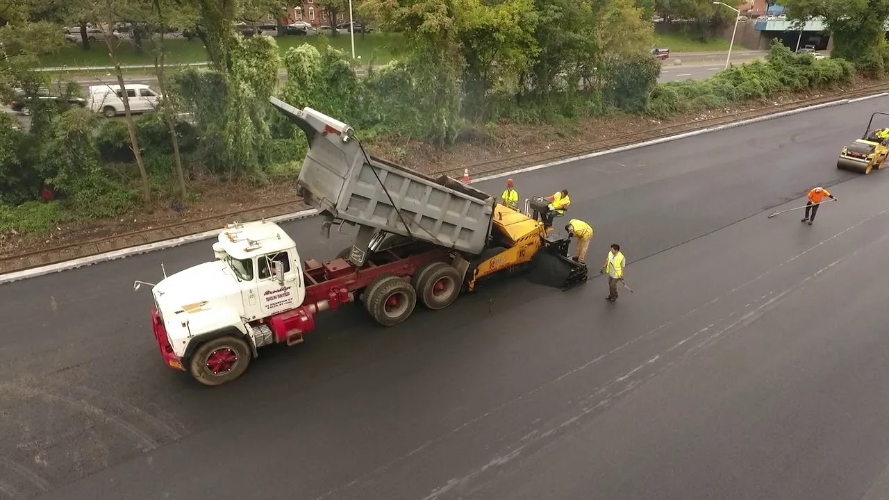 Licensed paving contractor by Grey Ruso in College Point, Queens — commercial asphalt crew at work